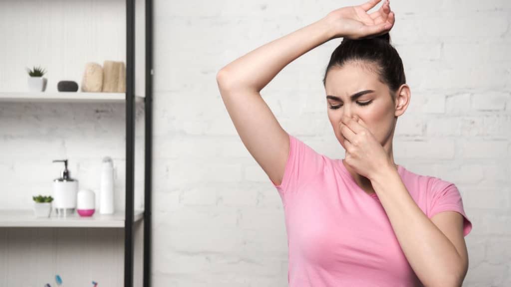 Image of a woman smelling bad smell