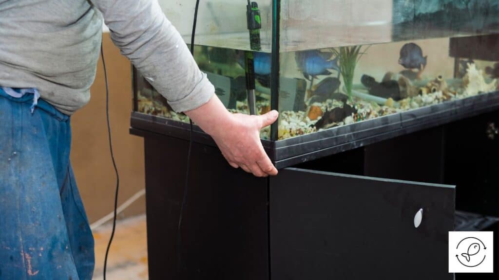 Man moving a fish tank